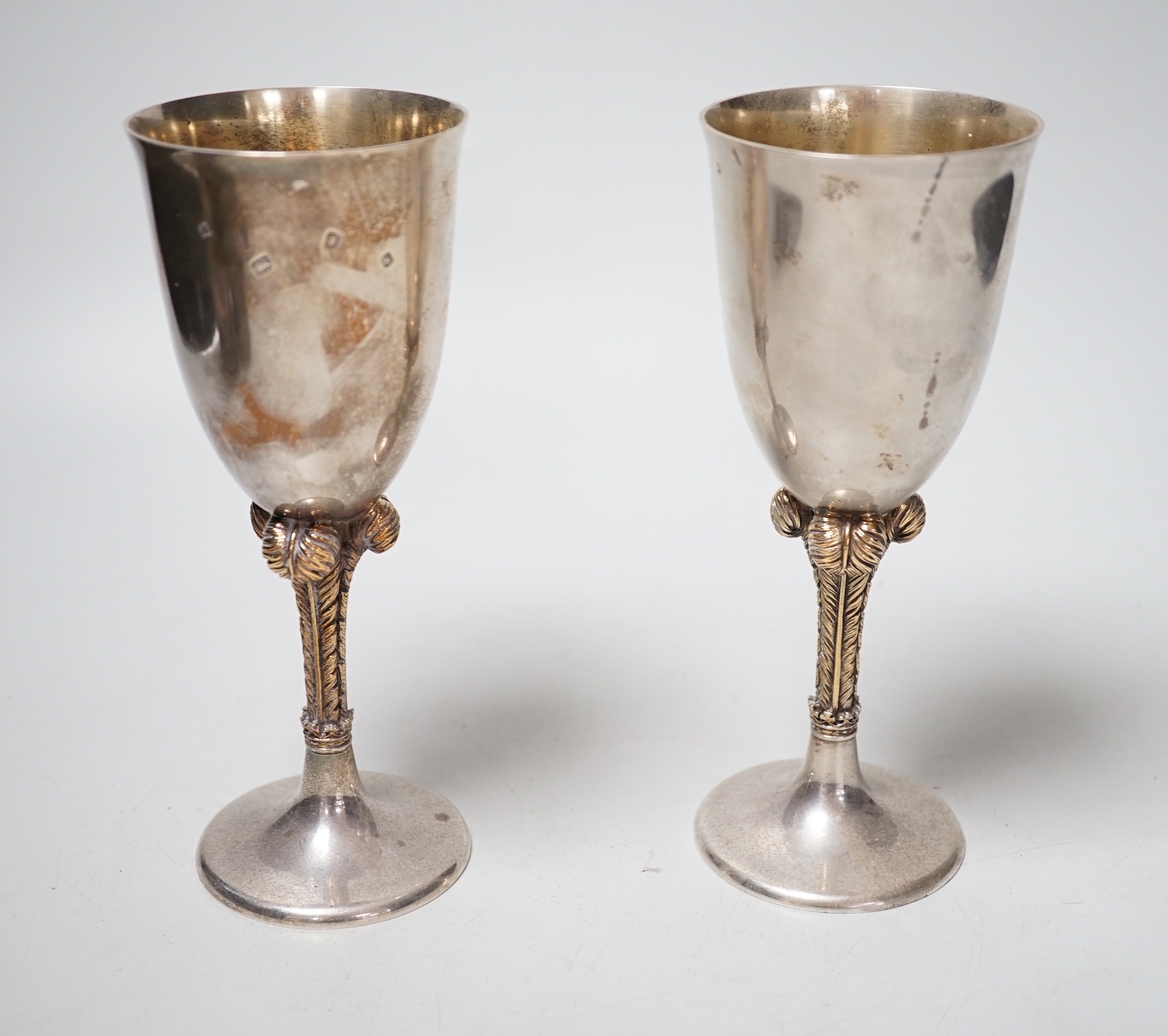 A pair of Elizabeth II silver goblets, with Prince of Wales feathers stem, St. James House Co. London, 1981, height 17.1cm, 12.8oz.